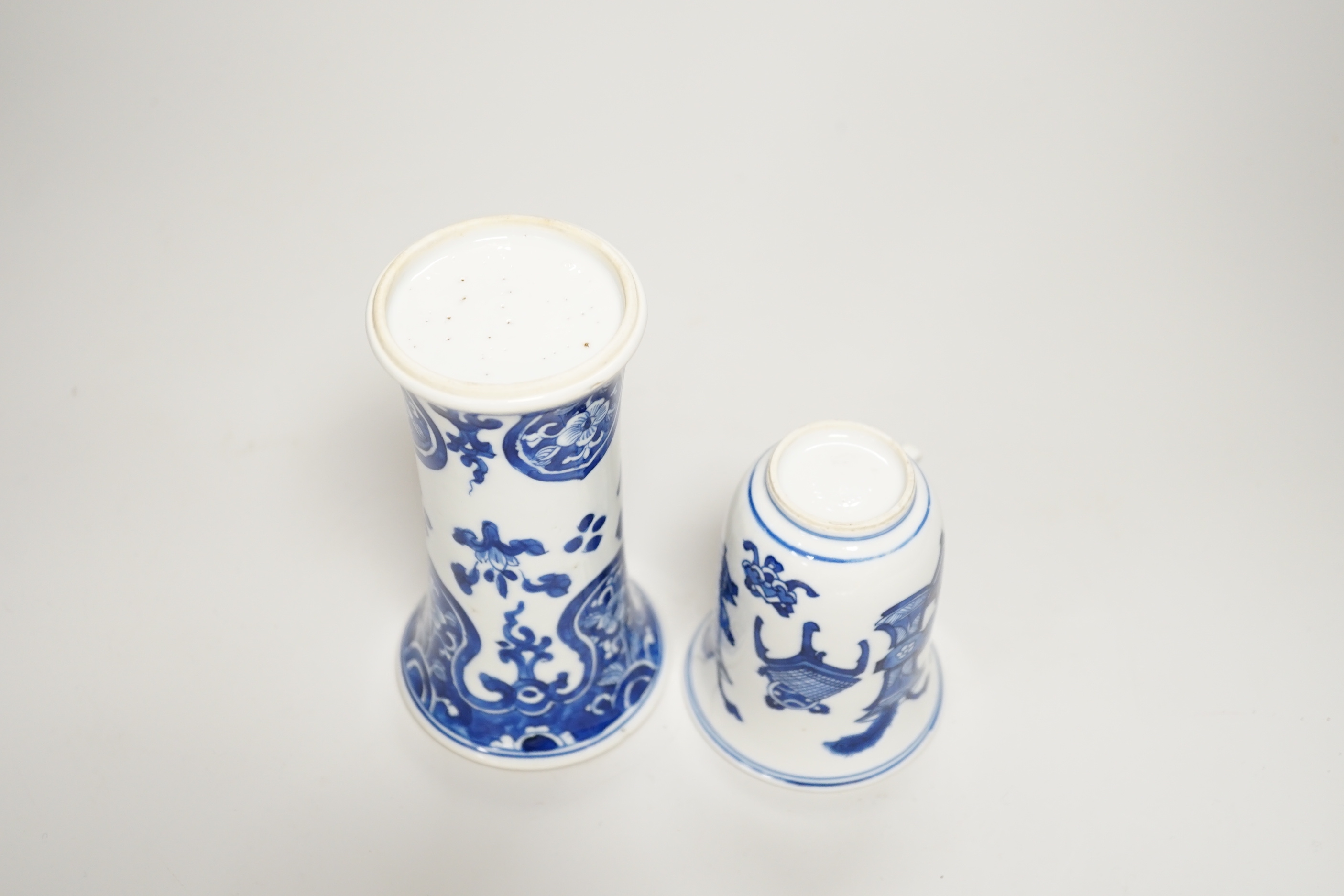 A Chinese blue and white small vase and a similar ‘Hundred Antiques’ chocolate cup, both Kangxi period, chocolate cup 9cms high